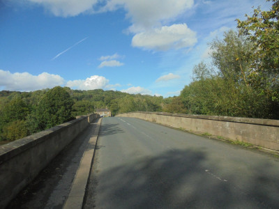 Surprisingly Sunny but a river in spate rushing under the bridge