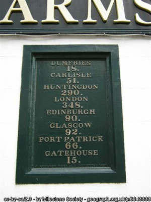 Old Milestone by the A713, King Street, Castle Douglas, Kelton Parish<br />By the A75, in parish of Kelton (Stewartry District), let into the wall of the "Douglas Arms", an old coaching inn.