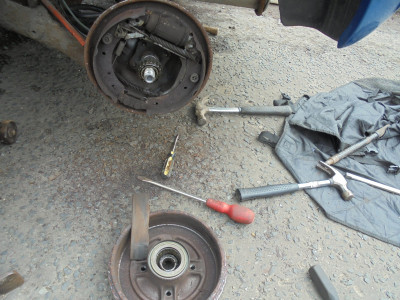 As expected a delaminated brake lining and 2 hours before the drum gave up the fight and came off.<br />Random arsenal of tools.  The genius of the claw hammers surprisingly proved the most effective.