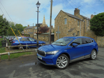 Skoda Enyaq Warkworth in the backgound