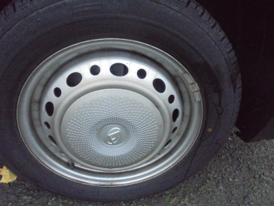 An unremarkable wheel, on an unremarkable van, with an unfamiliar badge. <br />Wonder what the make/model is?