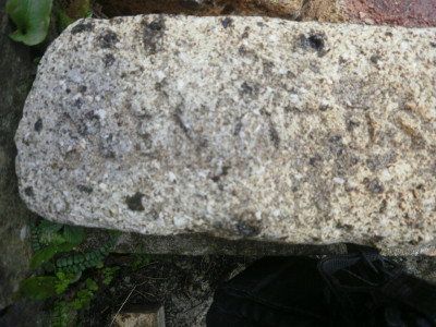 Indistinct weathered named brick found on spittal beach,  Berwick-upon-Tweed