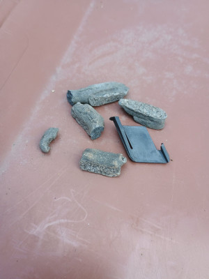 Rock hard lumps of seam sealer and a broken clip